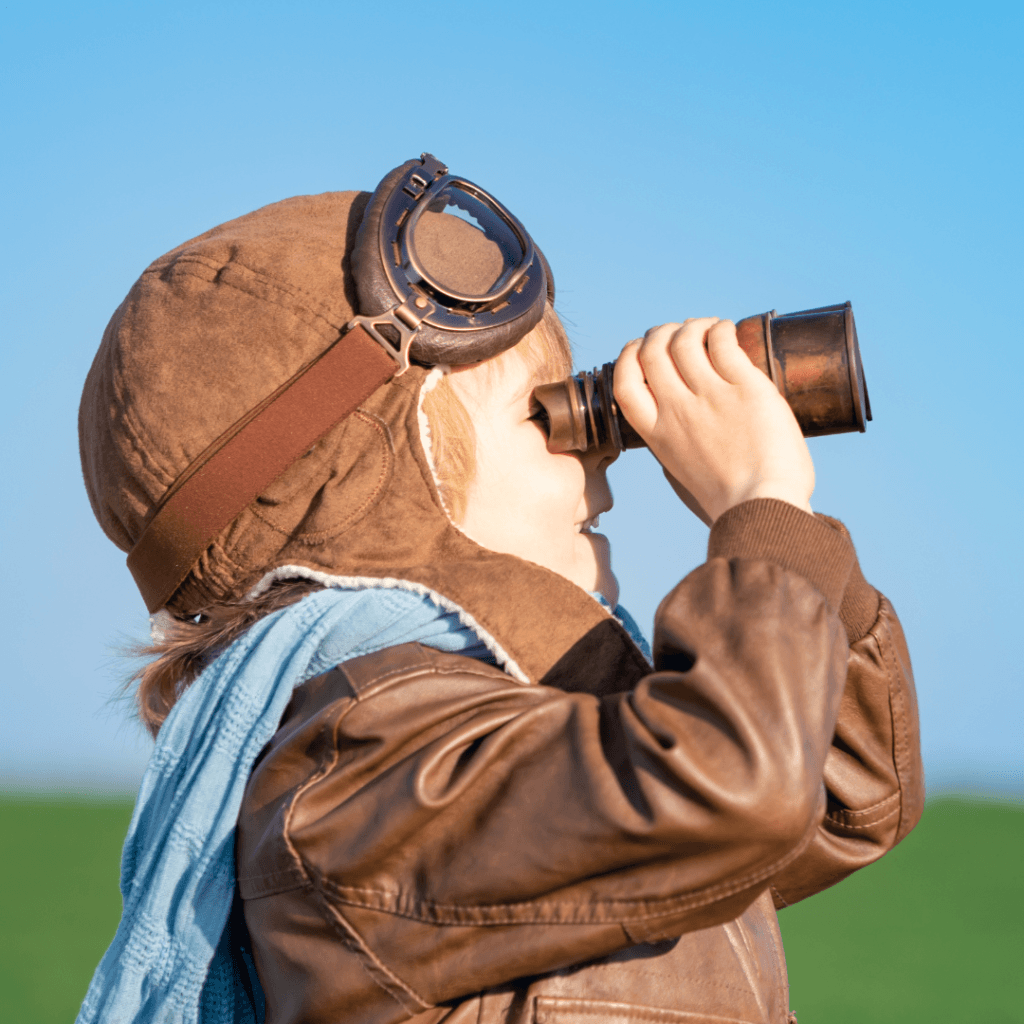 Boy looking through binoculars.